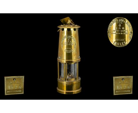 A Brass Miners Lamp Of traditional form, embossed badge to front 'Protector Lamp &amp; Lighting - Safety Lamps, Eccles' Tag t