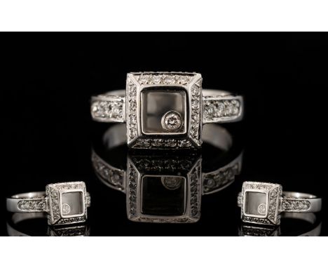 An 18ct White Gold And Diamond Set Chopard Style Floating Diamond Ring Fully hallmarked to shank, ring size K-L; the square c