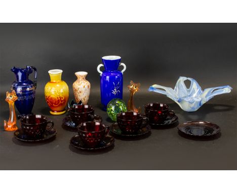 A Collection Of Decorative Glass Items To include five red moulded carnival glass cups and saucers, Venetian glass ewer, Mura