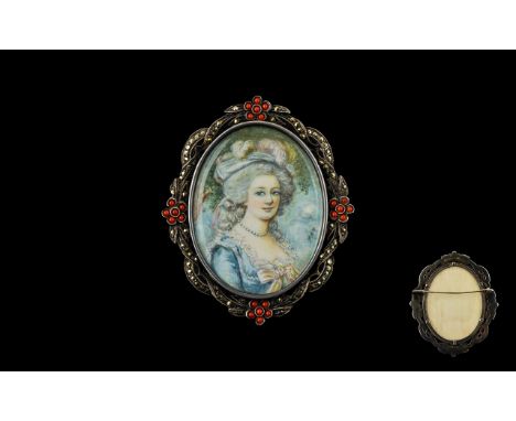 Antique Portrait Miniature Mounted in white metal frame with coral cabochon and marcasite ribbon and posy scroll border with 