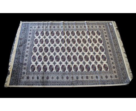 A Large Woven Silk Bokhara Carpet Ornate silk carpet with traditional  repeat design with intricate border detail. Beige grou