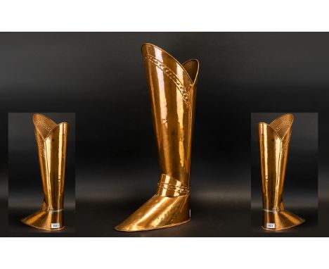  STICK STAND. Copper stick stand in the form of a military boot, comes with spurs which needs reattaching, stands at 21 inche