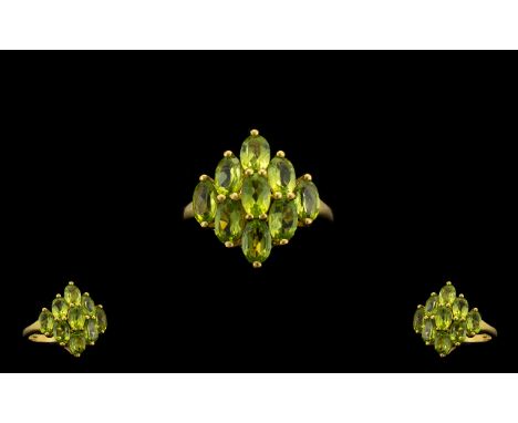 Peridot Diamond Shape Cluster Ring, nine oval cut peridots, totalling 4.5cts, closely set in a diamond shape, in 14ct gold ve