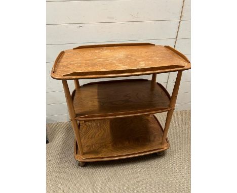 An Ercol blonde three tier trolley 