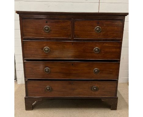 A mahogany chest of drawers on bracket feet (H109cm W106cm D54cm)