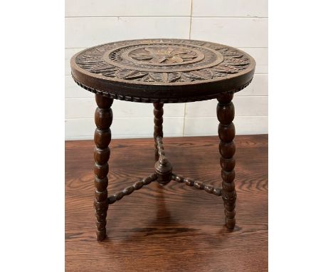 An oak carved circular table on bobbin tripod legs (H57cm Dia45cm)