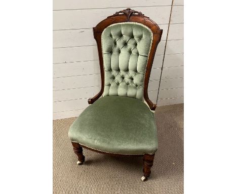 A button back slipper chair on turned legs and castors 