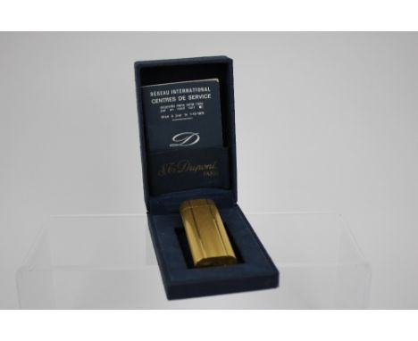 A Cartier gold plated cigarette lighter, circa 1970's, signed and numbered.
