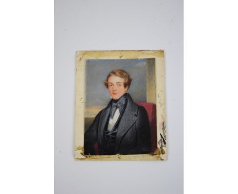An early 19th century half-length portrait miniature of a young gentleman wearing a black jacket, watercolour on ivory, 8.5cm