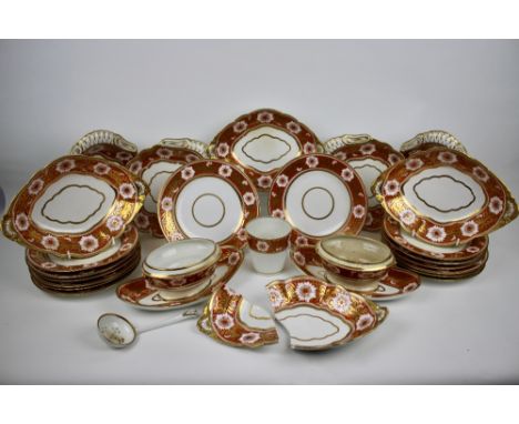 A Spode part dinner service , circa 1800 - 1820, decorated with stylised white flowers on a bright orange ground with gilt vi