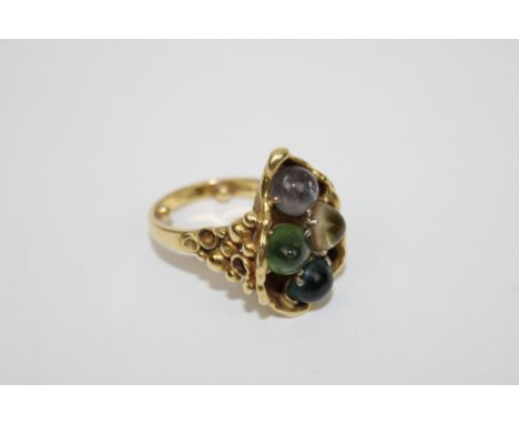 Gold and Gem set Ring, circa 1970, of organic design set with cabochon gem stones, including Peridot, Quartz and Citrine, sta