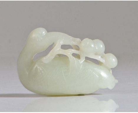 A Chinese jade carving, Qing Dynasty, 18th/19th Century, carved as a crane with its head turned to the rear and clutching a f