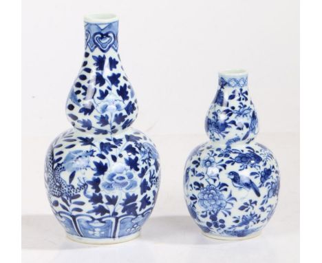 Two Chinese porcelain double gourd vases, both bearing the Kangxi four character mark but later, the first taller with a drag