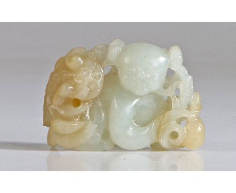 A Chinese white jade group, carved as a boy and Buddhist lion, the jovial figure crouching and holding a lingzhi fungus over 