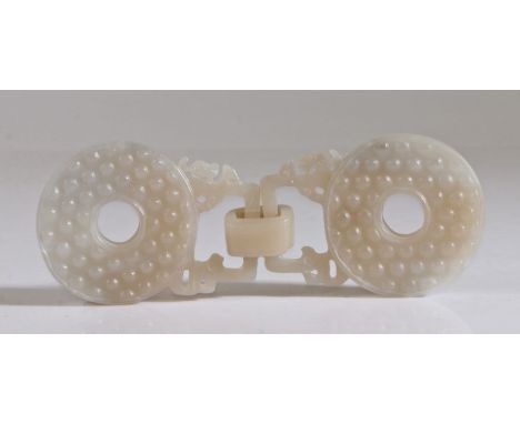 A Chinese jade buckle, Qing Dynasty, 19th Century, carved in one piece as two roundels and combined by a solid loop, 13cm lon