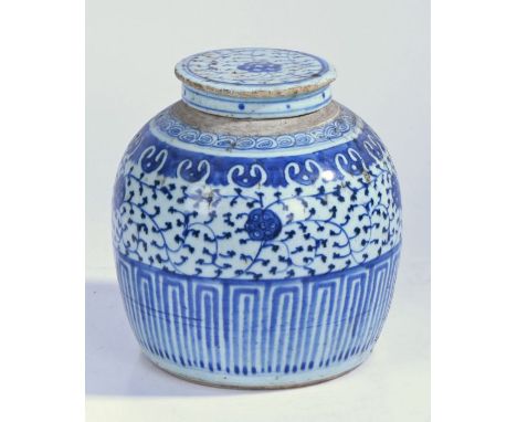 A Chinese porcelain ginger jar and cover, with blue leaf and scroll decoration, geometric base, 21cm high