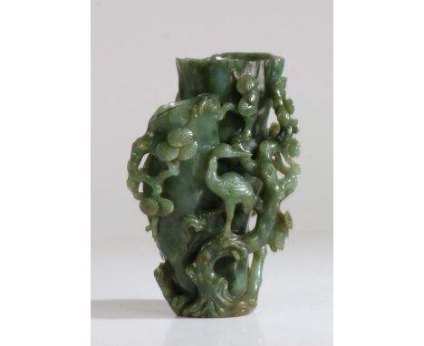 A Chinese spinach jade tree trunk double vase, Qing Dynasty, 18th Century, carved naturalistically in the form of two hollow 