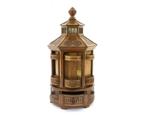 An Oak Smoker's Cabinet, 2nd half 19th century, in th form of a hexagonal pagoda, the lantern top with mirrored panels over s