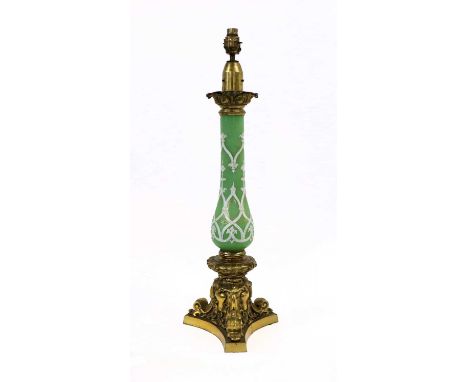 A French Gilt Metal Mounted Green Glass Oil Lamp Base, with leaf-cast captial with white enamel and gilt Gothic tracery, on a