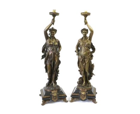 A Pair of French Style Bronzed Figural Lamp Bases, each as a classical maiden standing with arm raised, on stepped square bla