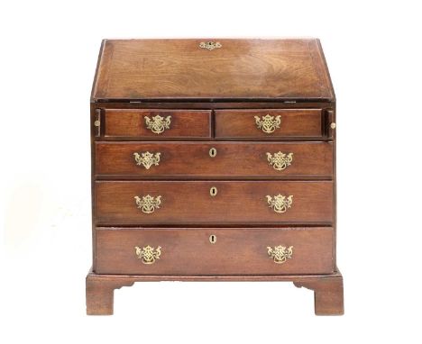 A George III Mahogany Bureau, 3rd quarter 18th century, the fall front enclosing seven small drawers and pigeon holes above t