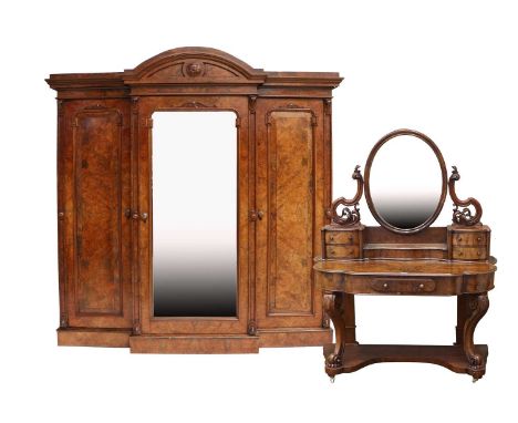 A Victorian Figured and Burr Walnut Triple-Door Breakfront Wardrobe, circa 1870, the architectural moulded pediment above a c