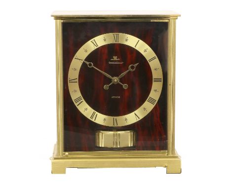 An Atmos Clock, signed Jaeger LeCoultre, model: Embassy, 20th Century, red faux marble side panels, red faux marble dial with