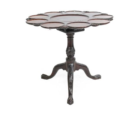 A George III Mahogany Tilt-Top Tripod Supper Table, late 18th century, the carved and moulded top with nine moulded panels fo