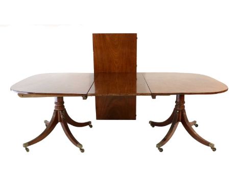 A Regency Mahogany Twin-Pedestal Dining Table, early 19th century, with two original additional leaves and later bearers, the