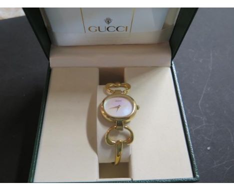 A ladies Gucci 1600 gold plated bangle wristwatch with oval case and Mother of Pearl face, simply marked Gucci, Swiss made, w