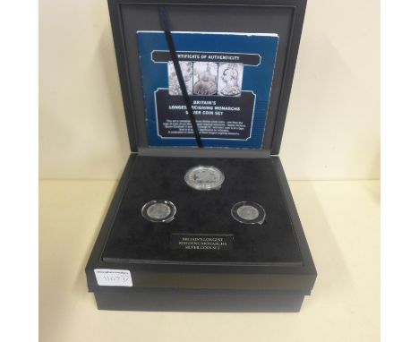 A boxed Bradford Exchange Britain's longest reigning monarchs silver three coin set 