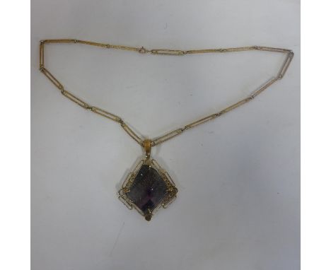 An interesting 9ct hallmarked gold amethyst pendant on a chain, pendant measures 7x5cm, approx 23 grams, chain 61cm long, app