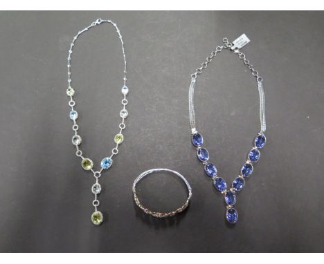 Three items of silver jewellery including mystic quartz necklace, gold on silver and diamond bangle and multi colour stone ne