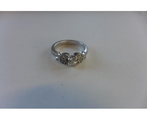 A hallmarked 18ct diamond ring, the central brilliant cut diamonds with shaped diamond encrusted shoulders, size J/K - approx