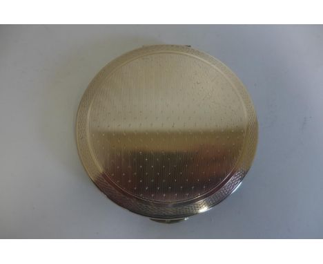 A silver compact by Kigu of London, in good condition, 7cm diameter 