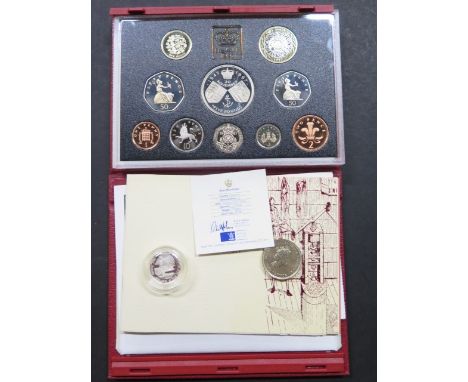 A 1997 proof coin set, a silver Guernsey £1 coin and a £2 coin 