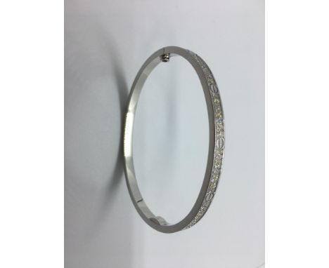 A Cartier white gold 18ct love bangle set with small diamonds signed Cartier number 17 DJF666 Au 750, measures 6cm x 5cm - ap