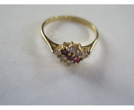 An 18ct hallmarked diamond and ruby ring, size O, approx 2.5 grams, generally good, diamonds bright, some general usage wear 