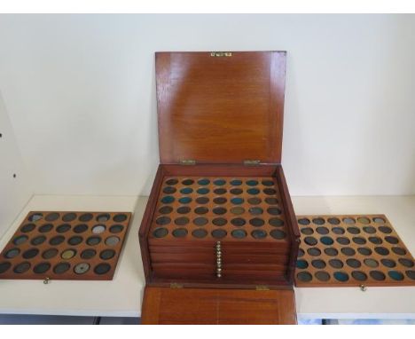 A mahogany coin case with twelve drawers, containing approx 300 coins tokens and medallions 