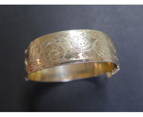A 9ct rolled gold Victorian style hinged bangle, marked 1/5 9ct rolled gold, weight approx 52.5 grams 