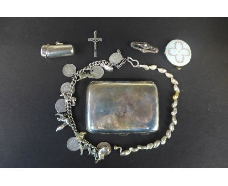 A silver charm bracelet, a silver bracelet, an enamel locket brooch and crucifix, and a silver cigarette case and a holder ca
