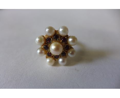 A 9ct gold pearl and garnet ring converted from a clasp, head is 2cm diameter, ring size O, approx 8.9 grams, generally good 