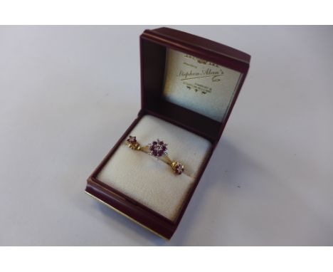 A hallmarked 18ct gold ruby and diamond ring, size K, approx 2.3 grams, and a pair of 9ct gold near matching earrings, approx