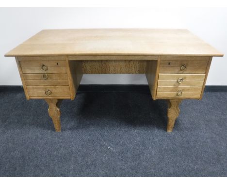 A continental light oak pedestal desk fitted six drawers 