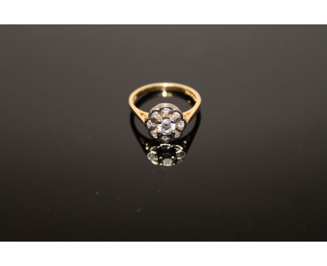 An 18ct gold diamond cluster ring, the central stone estimated at 0.3 carat