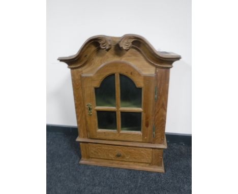 A continental light oak wall cabinet fitted a drawer 