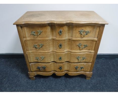 A continental light oak four drawer chest 