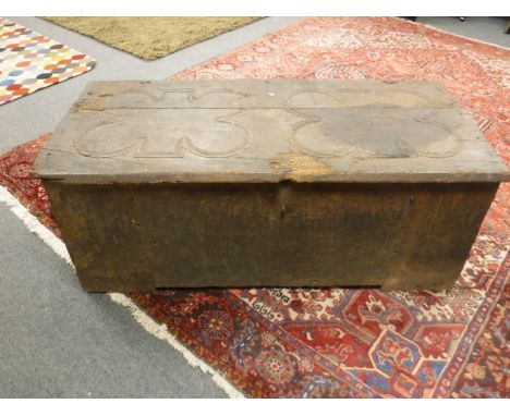 A nineteenth century oak shipping trunk with clover leaf detail to the lid