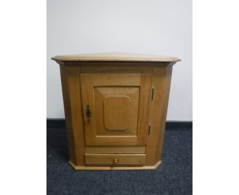 An antique style light oak corner cabinet 