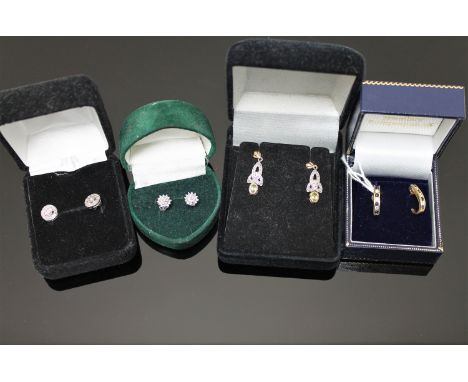 Three pairs of gold earrings and a pair of silver earrings